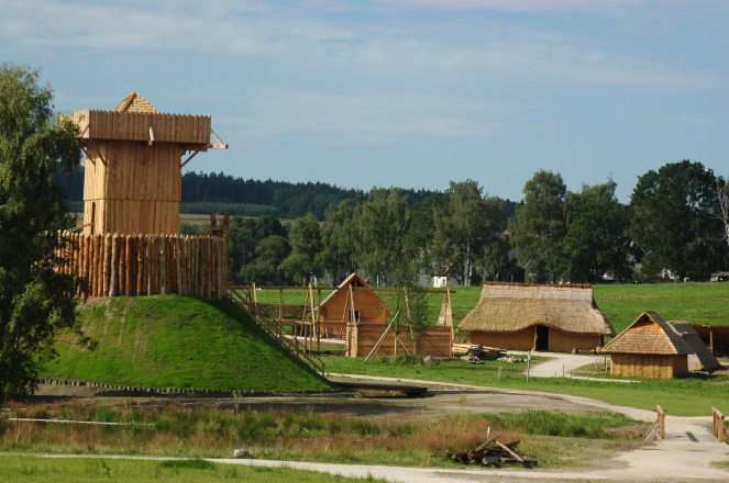 A reconstructed motte with wooden keep (image via Barbara Brunner on Wikimedia Commons)