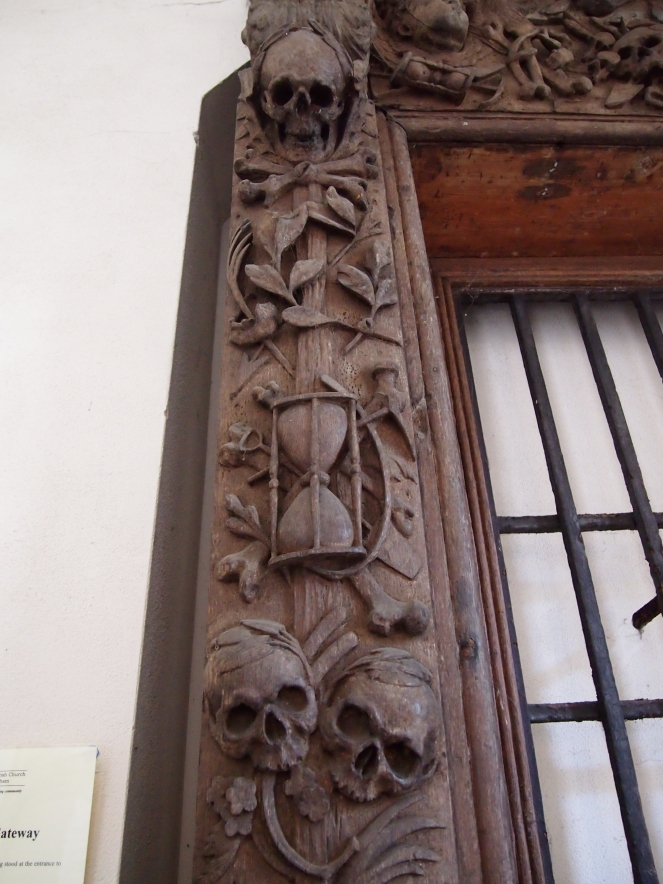Some of the memento mori carvings on the wooden gate that once stood outside All Hallows Lombard Street